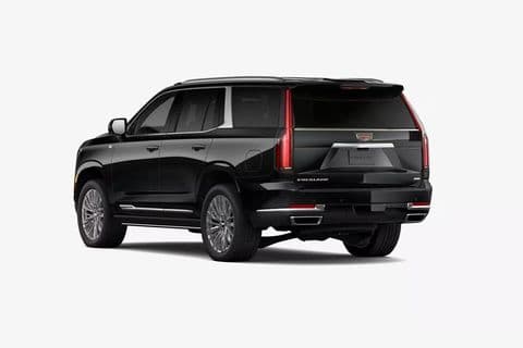 The Cadillac Escalade Platinum from the rear three-quarter, tailgate closed and the Cadillac crest on the liftgate.