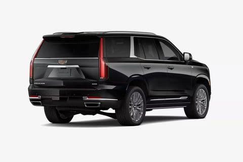 The Cadillac Escalade Platinum from the opposite rear three-quarter, running board and rear door in view.